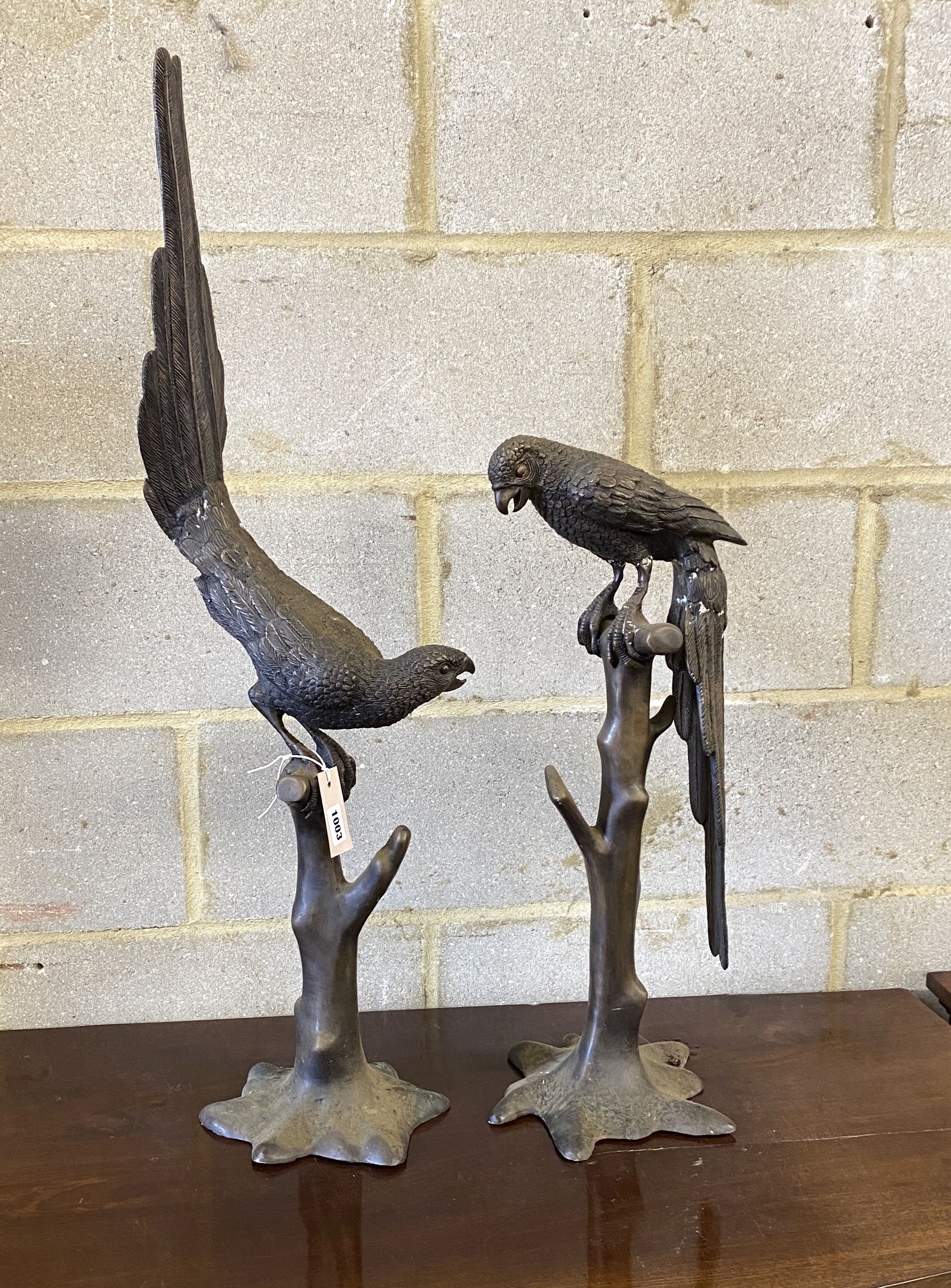 A pair of patinated cast metal macaws, larger height 88cm